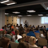 Wykład edukacyjny podczas Pomorskich Dni Energii. Sala wypełniona uczestnikami, słuchają prelekcji jednego z wykładowców